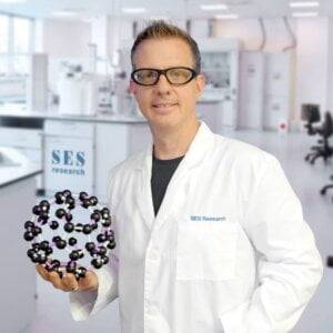 Chris Burres holding a C60 molecule model