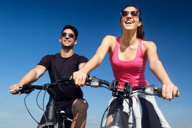 C60 FAQs and benefits - young couple on bicycle